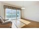 Sunlit living room featuring hardwood floors and sliding glass doors leading to a balcony at 4 Oceans West Blvd # 108B, Daytona Beach, FL 32118