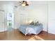 Bedroom with ceiling fan and access to bathroom at 4 Oceans West Blvd # 108B, Daytona Beach, FL 32118