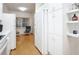 Kitchen features white cabinetry, refrigerator, and hardwood floors at 4 Oceans West Blvd # 108B, Daytona Beach, FL 32118