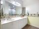 Double vanity bathroom with a decorative border and tiled floor at 4 Oceans West Blvd # 108B, Daytona Beach, FL 32118