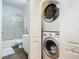 Bathroom with shower/tub combo, toilet and stackable washer/dryer at 4 Oceans West Blvd # 108B, Daytona Beach, FL 32118