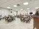 Bright community room with tables, chairs and holiday decor at 4 Oceans West Blvd # 108B, Daytona Beach, FL 32118