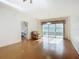 Spacious living area with hardwood floors and access to a bedroom and balcony at 4 Oceans West Blvd # 108B, Daytona Beach, FL 32118