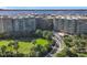 Aerial view of a condo building near the water with lush landscaping and a golf course at 4 Oceans West Blvd # 108B, Daytona Beach, FL 32118