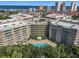 Aerial view of an apartment building with a pool and ocean view at 4 Oceans West Blvd # 108B, Daytona Beach, FL 32118