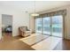 Bright living room with hardwood floors, sliding doors to balcony, and view of bedroom at 4 Oceans West Blvd # 108B, Daytona Beach, FL 32118