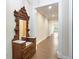 Long hallway with hardwood floors and antique furniture at 425 Sandy Bluff Trl, Deland, FL 32724
