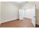 Small bedroom with wood-look flooring and neutral walls at 425 Sandy Bluff Trl, Deland, FL 32724