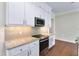 Modern kitchen with stainless steel appliances and white cabinets at 425 Sandy Bluff Trl, Deland, FL 32724
