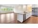 Modern kitchen with island, stainless steel appliances, and hardwood floors at 425 Sandy Bluff Trl, Deland, FL 32724