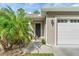 House exterior with a two-car garage and landscaped pathway at 425 Sandy Bluff Trl, Deland, FL 32724