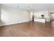 Open living room with hardwood floors and kitchen view at 425 Sandy Bluff Trl, Deland, FL 32724