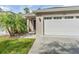 House exterior with a two-car garage and landscaped lawn at 425 Sandy Bluff Trl, Deland, FL 32724