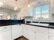 White kitchen with corner sink, dishwasher, and ample counter space at 600 N Boundary Ave # 106D, Deland, FL 32720
