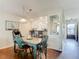 Dining area with teal table and chairs, view into kitchen at 600 N Boundary Ave # 106D, Deland, FL 32720