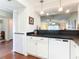 White kitchen with black countertops and built-in appliances at 600 N Boundary Ave # 106D, Deland, FL 32720
