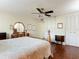 Primary bedroom with wood floors, ceiling fan and double closets at 600 N Boundary Ave # 106D, Deland, FL 32720