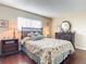 Cozy bedroom with floral bedding, wood floors, and a dresser at 600 N Boundary Ave # 106D, Deland, FL 32720