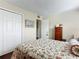 Bedroom with floral bedding and white closet doors at 600 N Boundary Ave # 106D, Deland, FL 32720