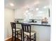 Kitchen features white cabinets, dark countertop, and breakfast bar at 600 N Boundary Ave # 106D, Deland, FL 32720