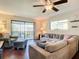 Living Room with sectional sofa, hardwood floors and sliding doors to balcony at 600 N Boundary Ave # 106D, Deland, FL 32720