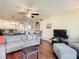 Living room with sectional sofa, hardwood floors and view into dining area at 600 N Boundary Ave # 106D, Deland, FL 32720