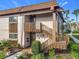 Exterior view of condo with private entrance and wooden staircase at 600 N Boundary Ave # 106D, Deland, FL 32720
