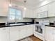 White kitchen with black countertops and stainless steel appliances at 600 N Boundary Ave # 106D, Deland, FL 32720