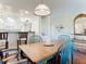 Bright dining area with a wood table and blue chairs, adjacent to kitchen at 600 N Boundary Ave # 106D, Deland, FL 32720