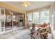 Sunroom with tiled floor, cat tree, and comfortable seating area at 6225 Cranberry Dr, Port Orange, FL 32127