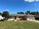 Single story home with attached garage and landscaped yard at 1008 Wilmington Dr, Deltona, FL 32725