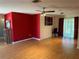 Living room with hardwood floors, accent wall and access to kitchen at 1008 Wilmington Dr, Deltona, FL 32725