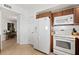 White appliances and wood cabinets in this well-lit kitchen at 1900 N Atlantic Ave # 1601, Daytona Beach, FL 32118