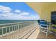 Ocean view balcony with patio table and chairs at 1900 N Atlantic Ave # 1601, Daytona Beach, FL 32118