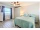 Cozy bedroom with a queen bed, built in closet, and ceiling fan at 3333 S Atlantic Ave # 605, Daytona Beach Shores, FL 32118