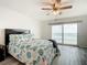 Main bedroom with ocean view, ceiling fan, and comfy bedding at 3333 S Atlantic Ave # 605, Daytona Beach Shores, FL 32118