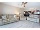 Open living space with leather sofas, tile floors, and kitchen view at 3333 S Atlantic Ave # 605, Daytona Beach Shores, FL 32118