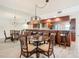 Dining area with glass table and rattan chairs at 3333 S Atlantic Ave # 605, Daytona Beach Shores, FL 32118