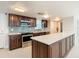 Modern kitchen featuring dark wood cabinets and a large island at 3333 S Atlantic Ave # 605, Daytona Beach Shores, FL 32118