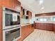 Modern kitchen with stainless steel appliances and wood cabinets at 3333 S Atlantic Ave # 605, Daytona Beach Shores, FL 32118