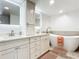 Spa-like bathroom with double vanity, large bathtub, and tile floors at 3333 S Atlantic Ave # 605, Daytona Beach Shores, FL 32118