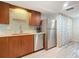 Modern kitchen featuring stainless steel appliances and wood cabinetry at 3333 S Atlantic Ave # 605, Daytona Beach Shores, FL 32118