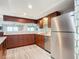 Kitchen with stainless steel appliances and wood cabinets at 3333 S Atlantic Ave # 605, Daytona Beach Shores, FL 32118