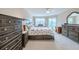 Bright bedroom with large windows, carpet flooring, and a ceiling fan at 4 Oceans West Blvd # 301C, Daytona Beach Shores, FL 32118