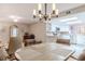 Dining area with kitchen view, featuring a chandelier and hardwood floors at 4 Oceans West Blvd # 301C, Daytona Beach Shores, FL 32118