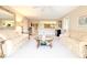 Open living room with view to kitchen and neutral carpeting at 4 Oceans West Blvd # 301C, Daytona Beach Shores, FL 32118