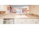 Bright kitchen features white cabinets, granite countertops, and a double sink at 4 Oceans West Blvd # 301C, Daytona Beach Shores, FL 32118