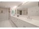 Double vanity bathroom with updated fixtures and a large mirror at 4 Oceans West Blvd # 301C, Daytona Beach Shores, FL 32118