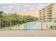 View from balcony of resort-style pool and lush landscaping at 4 Oceans West Blvd # 301C, Daytona Beach Shores, FL 32118