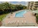 Community pool with plenty of lounge chairs for relaxation at 4 Oceans West Blvd # 301C, Daytona Beach Shores, FL 32118